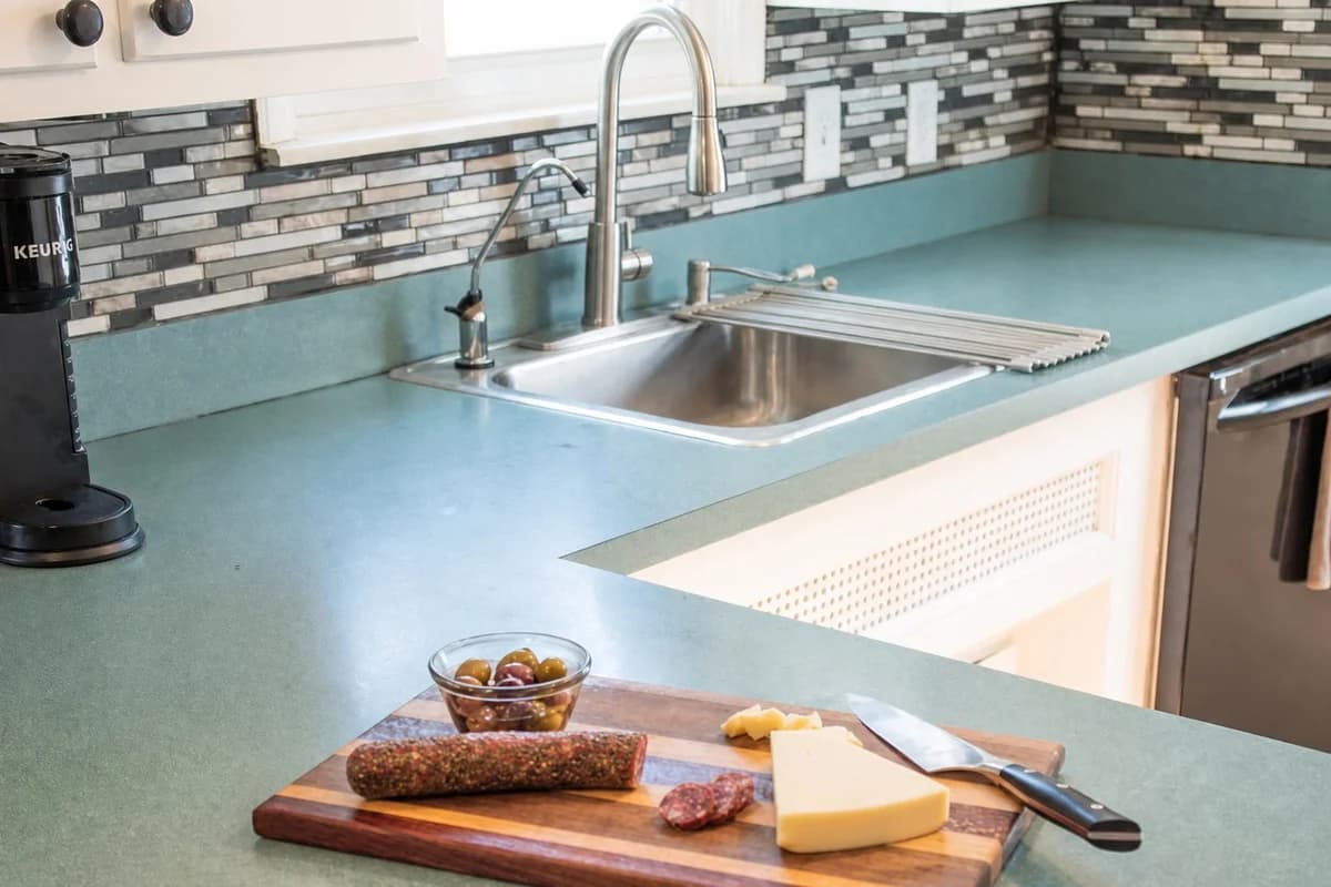Kitchen counter, sink and tiled backsplash